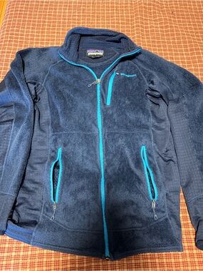 Patagonia Navy Fleece Jacket with Bright Teal Accents
